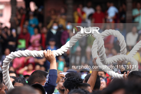 Nepali Hindu devotees pull a sacred pole locally called ''Ya: Shi,'' marking the formal start of Indra Jatra dedicated to the rain god Indra...