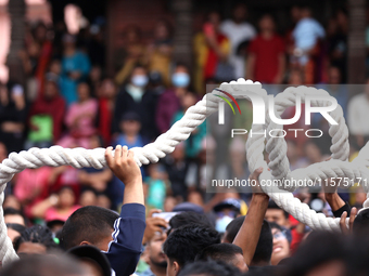 Nepali Hindu devotees pull a sacred pole locally called ''Ya: Shi,'' marking the formal start of Indra Jatra dedicated to the rain god Indra...