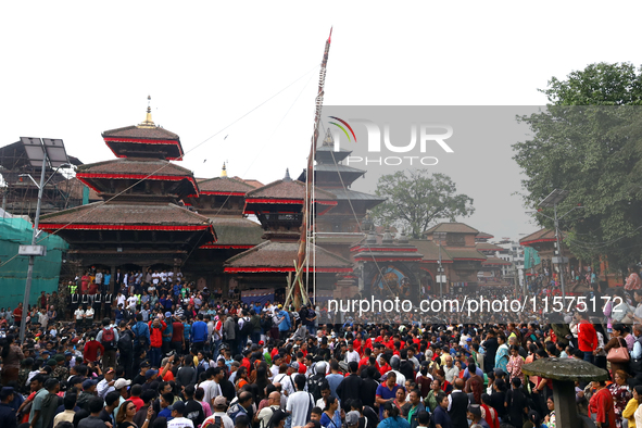 Nepali Hindu devotees pull a sacred pole locally called ''Ya: Shi,'' marking the formal start of Indra Jatra dedicated to the rain god Indra...