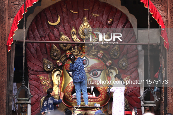 Nepali Hindu devotees clean the mask of the Nepali Hindu god Swet Bhairab ahead of the formal start of Indra Jatra dedicated to the rain god...