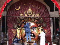 Nepali Hindu devotees clean the mask of the Nepali Hindu god Swet Bhairab ahead of the formal start of Indra Jatra dedicated to the rain god...