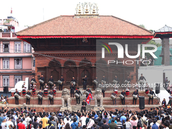 A Nepali musical band dons Newari attire and plays traditional musical instruments ahead of the formal start of Indra Jatra dedicated to the...