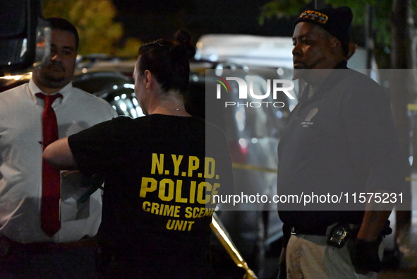 Investigators from the NYPD Crime Scene Unit investigate and place evidence markers and take photographs of the scene. One man is dead and a...