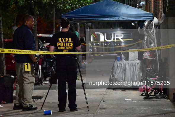 Investigators from the NYPD Crime Scene Unit investigate and place evidence markers and take photographs of the scene. One man is dead and a...