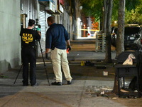 Investigators from the NYPD Crime Scene Unit investigate and place evidence markers and take photographs of the scene. One man is dead and a...