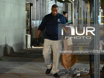 Investigators from the NYPD Crime Scene Unit investigate and place evidence markers and take photographs of the scene. One man is dead and a...