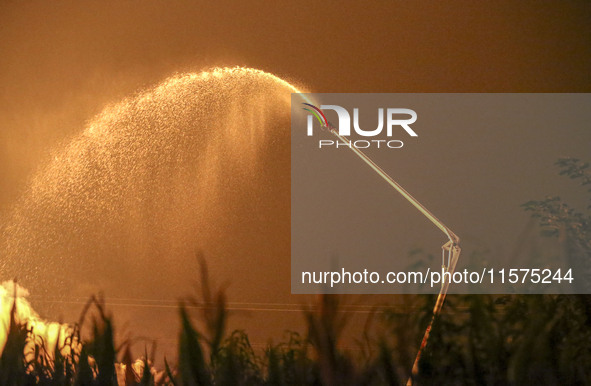 Fire crews work to put out a fire at a wood processing plant in Duzhuang village, Wan'an Town, Xinjiang County, Yuncheng City, North China's...