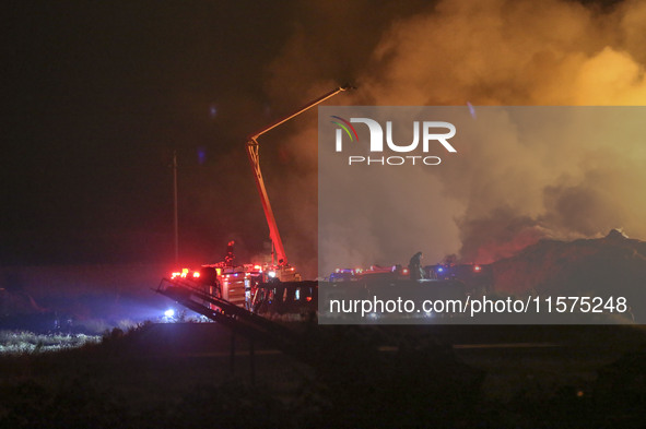 Fire crews work to put out a fire at a wood processing plant in Duzhuang village, Wan'an Town, Xinjiang County, Yuncheng City, North China's...