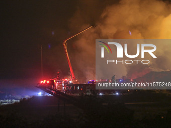 Fire crews work to put out a fire at a wood processing plant in Duzhuang village, Wan'an Town, Xinjiang County, Yuncheng City, North China's...