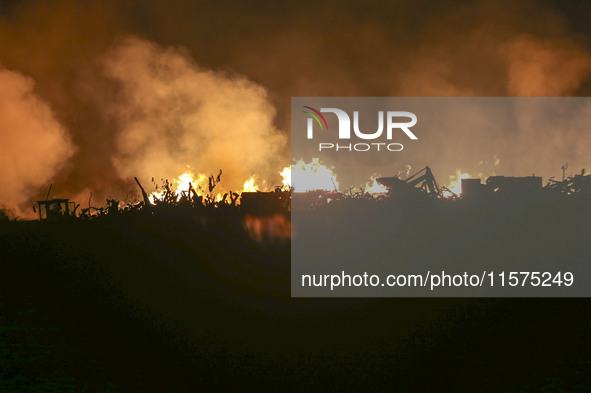 Fire crews work to put out a fire at a wood processing plant in Duzhuang village, Wan'an Town, Xinjiang County, Yuncheng City, North China's...