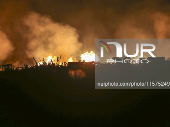 Fire crews work to put out a fire at a wood processing plant in Duzhuang village, Wan'an Town, Xinjiang County, Yuncheng City, North China's...