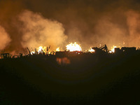 Fire crews work to put out a fire at a wood processing plant in Duzhuang village, Wan'an Town, Xinjiang County, Yuncheng City, North China's...