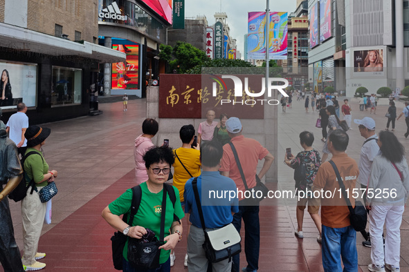 Tourists are seen on the Nanjing Road Pedestrian Street on the first day of the Mid-Autumn Festival holiday in Shanghai, China, on September...