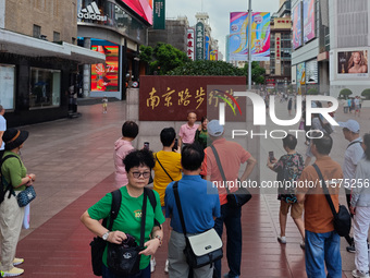 Tourists are seen on the Nanjing Road Pedestrian Street on the first day of the Mid-Autumn Festival holiday in Shanghai, China, on September...