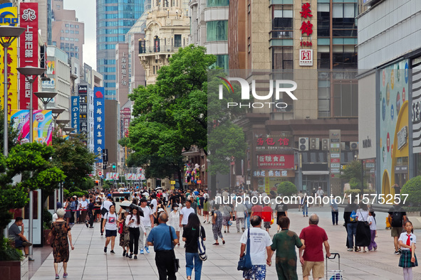 Tourists are seen on the Nanjing Road Pedestrian Street on the first day of the Mid-Autumn Festival holiday in Shanghai, China, on September...