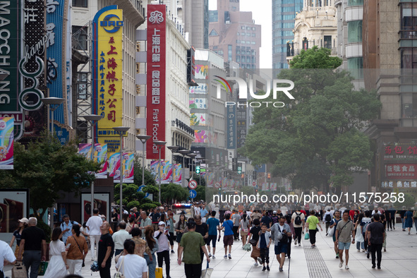 Tourists are seen on the Nanjing Road Pedestrian Street on the first day of the Mid-Autumn Festival holiday in Shanghai, China, on September...