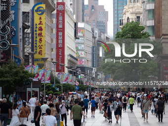 Tourists are seen on the Nanjing Road Pedestrian Street on the first day of the Mid-Autumn Festival holiday in Shanghai, China, on September...