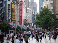 Tourists are seen on the Nanjing Road Pedestrian Street on the first day of the Mid-Autumn Festival holiday in Shanghai, China, on September...