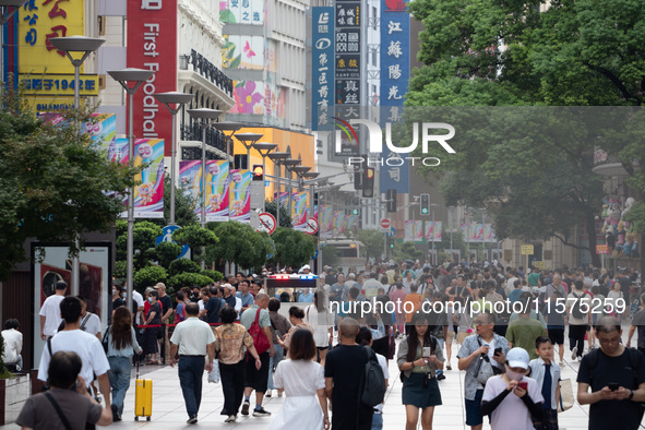 Tourists are seen on the Nanjing Road Pedestrian Street on the first day of the Mid-Autumn Festival holiday in Shanghai, China, on September...