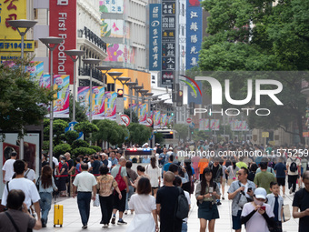 Tourists are seen on the Nanjing Road Pedestrian Street on the first day of the Mid-Autumn Festival holiday in Shanghai, China, on September...