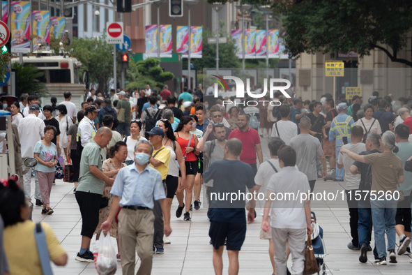 Tourists are seen on the Nanjing Road Pedestrian Street on the first day of the Mid-Autumn Festival holiday in Shanghai, China, on September...