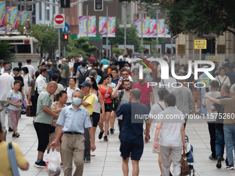 Tourists are seen on the Nanjing Road Pedestrian Street on the first day of the Mid-Autumn Festival holiday in Shanghai, China, on September...