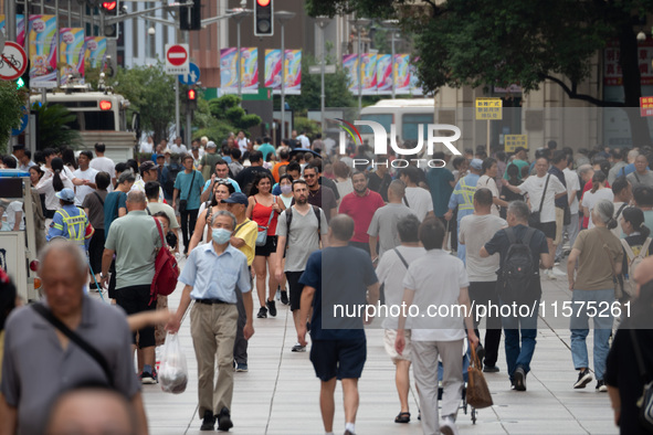 Tourists are seen on the Nanjing Road Pedestrian Street on the first day of the Mid-Autumn Festival holiday in Shanghai, China, on September...