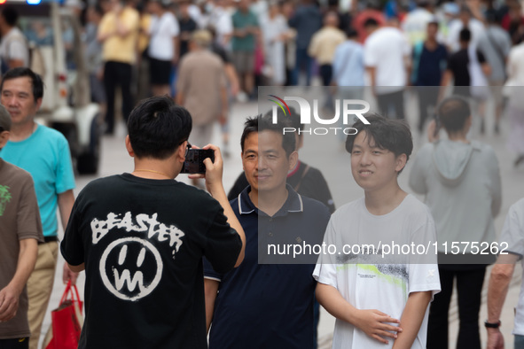 Tourists are seen on the Nanjing Road Pedestrian Street on the first day of the Mid-Autumn Festival holiday in Shanghai, China, on September...