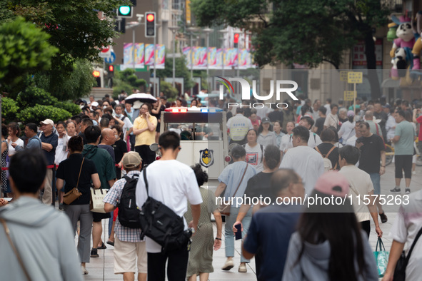 Tourists are seen on the Nanjing Road Pedestrian Street on the first day of the Mid-Autumn Festival holiday in Shanghai, China, on September...