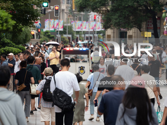 Tourists are seen on the Nanjing Road Pedestrian Street on the first day of the Mid-Autumn Festival holiday in Shanghai, China, on September...