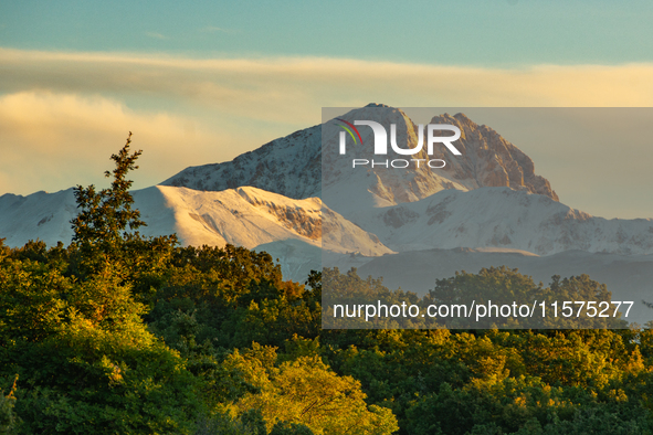 Snowy Corno Grande peak (Gran Sasso d’Italia and Monti della Laga National Park) is seen above trees after a snowfall from Ocre (L’Aquila),...