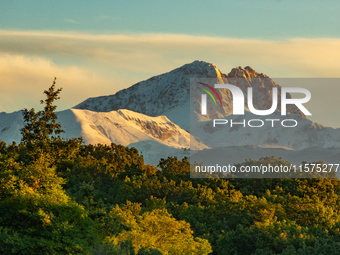 Snowy Corno Grande peak (Gran Sasso d’Italia and Monti della Laga National Park) is seen above trees after a snowfall from Ocre (L’Aquila),...