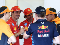 Lando Norris of McLaren, Charles Leclerc, Carlos Sainz of Ferrari, Max Verstappen of Red Bull Racing and Lando Norris of McLaren ahead of th...