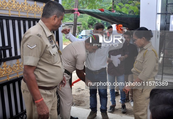 A police officer checks aspirants as they enter an examination hall to appear in the Assam Direct Recruitment Exam 2024 (ADRE) for filling u...