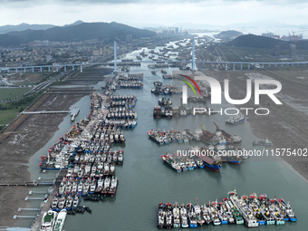 A large number of fishing boats moor at Shenjiamen Fishing Port to avoid Typhoon Bebinca in Zhoushan, China, on September 15, 2024. (