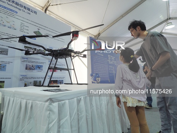 A child visits a ''drone'' during the 14th Beijing Science Carnival in Beijing, China, on September 15, 2024. 