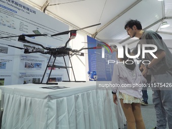 A child visits a ''drone'' during the 14th Beijing Science Carnival in Beijing, China, on September 15, 2024. (