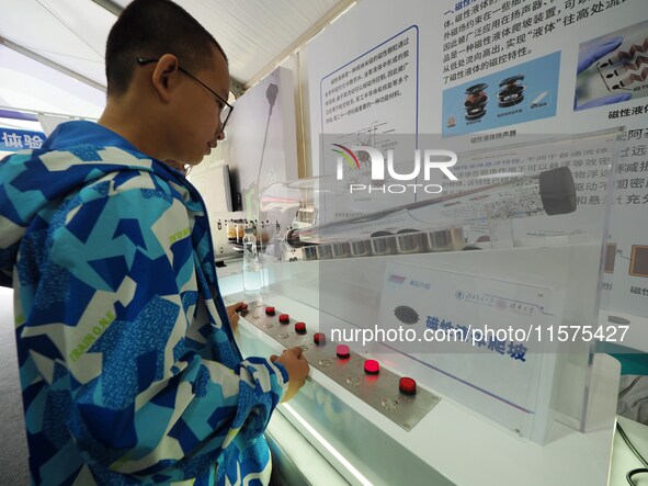 Children experience ''magnetic liquid climbing'' during the 14th Beijing Science Carnival in Beijing, China, on September 15, 2024. 