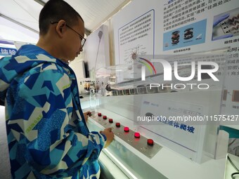 Children experience ''magnetic liquid climbing'' during the 14th Beijing Science Carnival in Beijing, China, on September 15, 2024. (