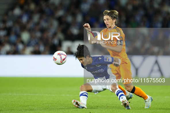 Takefusa Kubo right winger of Real Sociedad and Japan and Luka Modric central midfield of Real Madrid and Croatia compete for the ball durin...