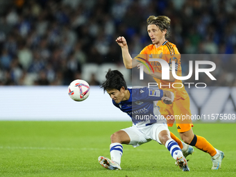 Takefusa Kubo right winger of Real Sociedad and Japan and Luka Modric central midfield of Real Madrid and Croatia compete for the ball durin...