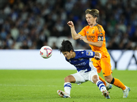 Takefusa Kubo right winger of Real Sociedad and Japan and Luka Modric central midfield of Real Madrid and Croatia compete for the ball durin...