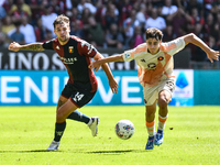 Nicolo Pisilli of Roma contrasts Alessandro Vogliacco of Genoa during the Serie A ENILIVE 24/25 match between Genoa CFC and AS Roma at Stadi...