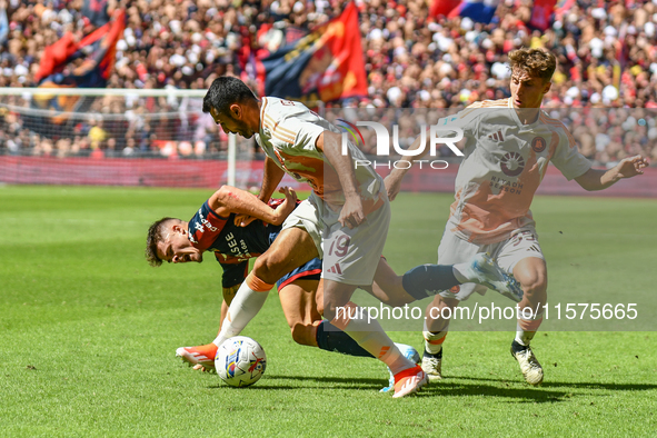 #19 Zeki Celik of Roma contrasts #9 Vitinha of Genoa during the Serie A ENILIVE 24/25 match between Genoa CFC and AS Roma at Stadio Luigi Fe...