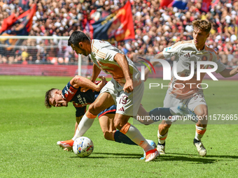 #19 Zeki Celik of Roma contrasts #9 Vitinha of Genoa during the Serie A ENILIVE 24/25 match between Genoa CFC and AS Roma at Stadio Luigi Fe...