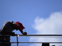 A worker welds an aluminum bar in Kirtipur, Kathmandu, Nepal, on September 15, 2024. He earns a monthly income of NRs. 15,000 (US$ 150) (