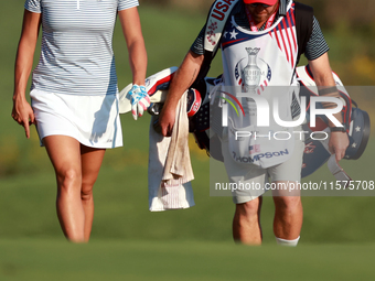 GAINESVILLE, VIRGINIA - SEPTEMBER 14: Lexi Thompson of the United States walks with her caddie on the 17th fairway during Day Two of the Sol...