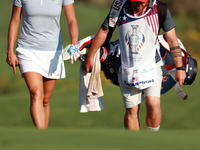 GAINESVILLE, VIRGINIA - SEPTEMBER 14: Lexi Thompson of the United States walks with her caddie on the 17th fairway during Day Two of the Sol...