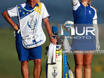 GAINESVILLE, VIRGINIA - SEPTEMBER 14: Emily Kristine Pedersen of Team Europe tosses a handful of blades of grass in the air on the 17th fair...