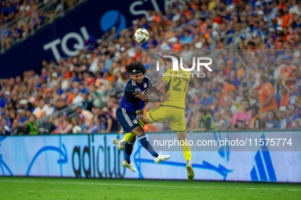 Cincinnati defender DeAndre Yedlin and Columbus defender Max Arfsten compete for the ball during the 'Hell is Real' Major League Soccer matc...